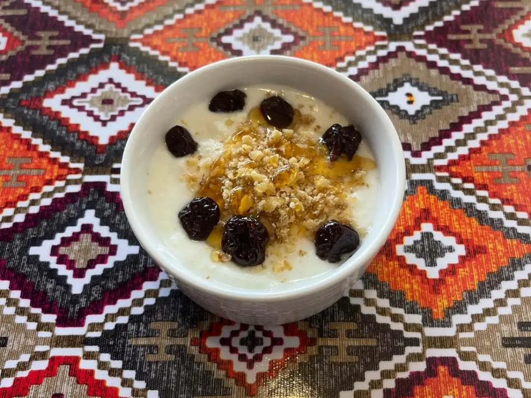 Yogurt topped with dried fruits and nuts at Babahan Uyghur Cafe, a Chinese Xinjiang Flavors Restaurant in Plano